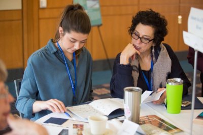 Two people talking over coffee